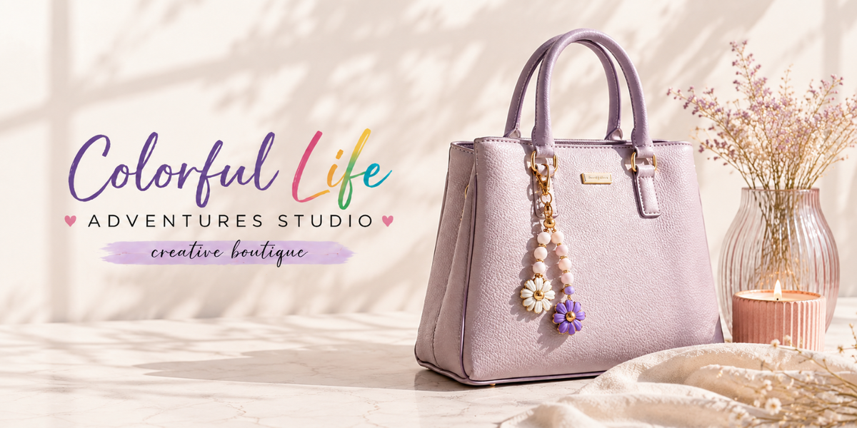 A lavender purple textured leather handbag with dual top handles, a decorative floral charm, and a small gold brand plaque, styled on a light marble surface next to a candle and dried flowers. The text 'Colorful Life ADVENTURES STUDIO creative boutique' is displayed on the left.